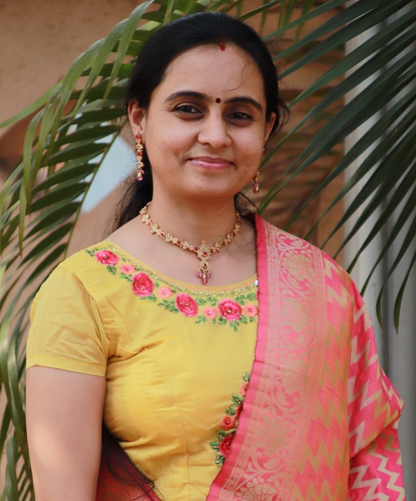 Poonam Patil, wearing a yellow embroidered blouse and a pink and gold saree